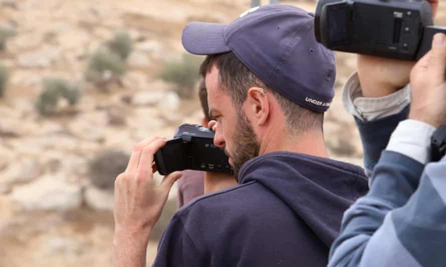 Itai Feitelson films Israeli settlers as they get close to the Palestinian village of Twani. Violence against Palestinians happens often in the area.