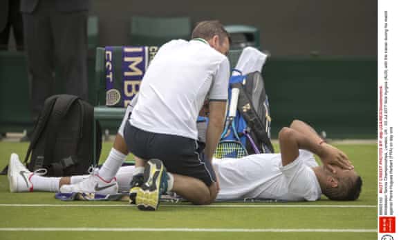 Nick Kyrgios (AUS) with the trainer during his match against Pierre-Hugues Herbert (FRA) on day one Wimbledon Tennis Championships,