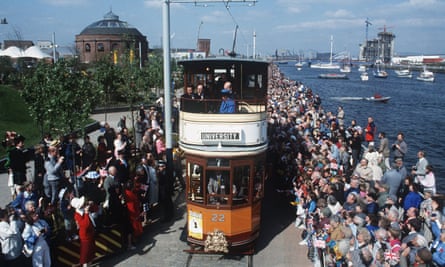 Crowds around a tram at the Glasgow Garden Festival, greeting Princess Diana, in blue, on the top deck.