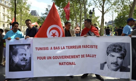 Protesters hold a banner reading ‘Tunisia: Down with fascist terror’.