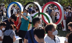 Coronavirus live news: Tokyo has 1,359 new cases on first day of Olympics; Malaysia reports record daily cases 3 Crowds at the Olympic rings outside the Olympic stadium in Tokyo today ahead of the opening ceremony.