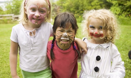 Three girls with faces painted, one as a red squirrel.