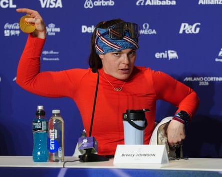 Olympic downhill champion Breezy Johnson shows her broken medal to the media.