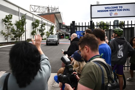 Crowds watch Range Rover outside football oval