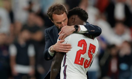 England’s manager Gareth Southgate embraces Bukayo Saka after the player’s missed penalty in the final of Euro 2020.