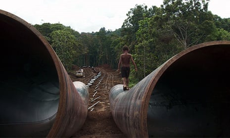 A boy walks on the Exxon Mobil LNG pipe in Papua New Guinea.