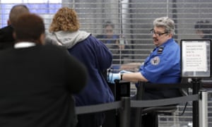 TSA officers work at a checkpoint at O’Hare airport in Chicago on Friday.