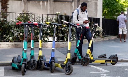 A man books an electric scooter from Dott, one of the French capital’s three operators.