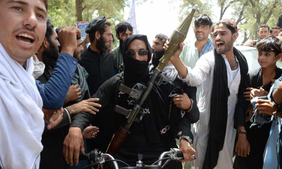 A Taliban militant among residents in Jalalabad during the ceasefire