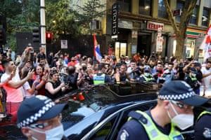Supporters of Serbian tennis player Novak Djokovic gather around a car outside what is believed to be the location of his lawyer’s office during a day of legal proceedings over the cancellation of his visa to play in the Australian Open.
