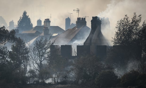 Smoke around houses in the village of Wennington in east London