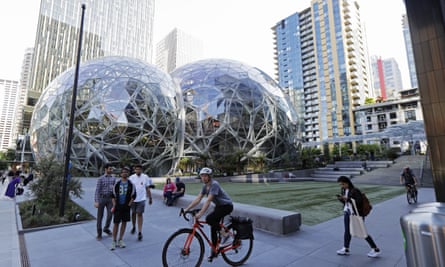 Pedestrians and cyclists gather near the Bezos balls in Seattle. The conservatories are modelled on the greenhouses at London’s Kew Gardens.