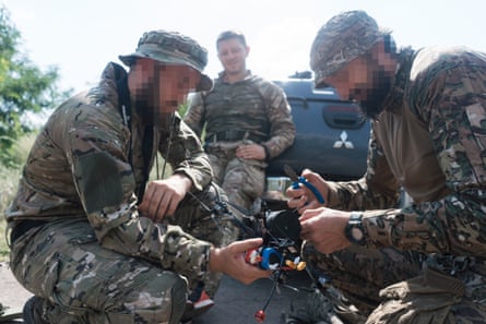 Left to right: Oleksandr, Olexsandr and Petro get ready to set up an FPV drone.