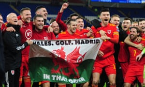 Gareth Bale celebrates after Wales beat Hungary in November 2019 to qualify for Euro 2020, with a flag saying: “Wales. Golf. Madrid. In that order”.