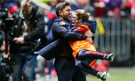 Lee Johnson celebrates with a ball boy after Bristol City’s late winner.