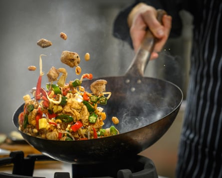 Vegetables being flipped in a wok