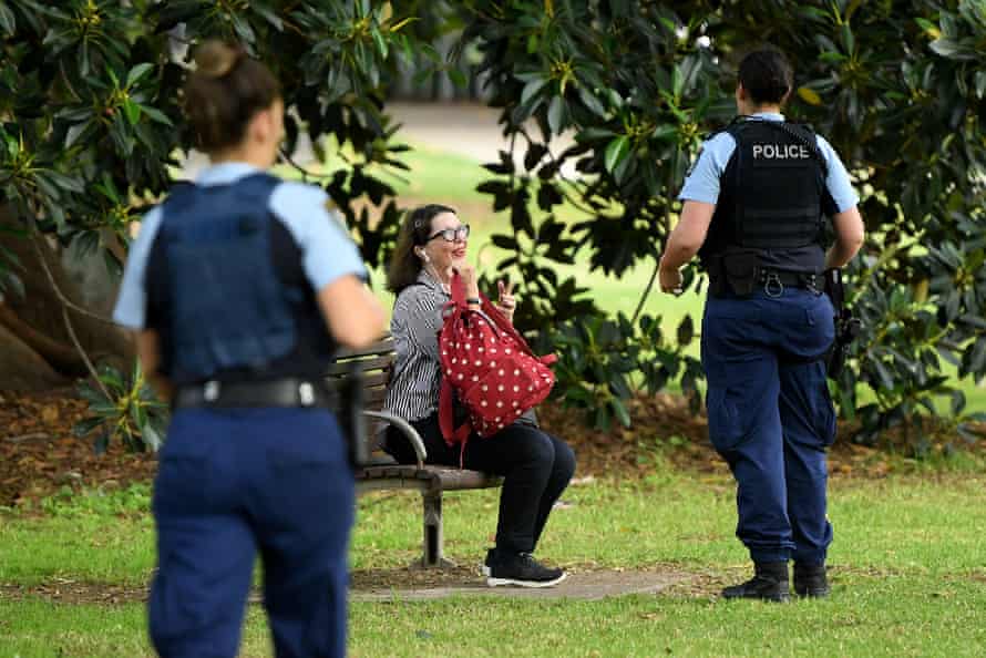 NSW Police officers ask people to move on while on patrol at Rushcutters Bay park in Sydney, Wednesday, April 1, 2020.