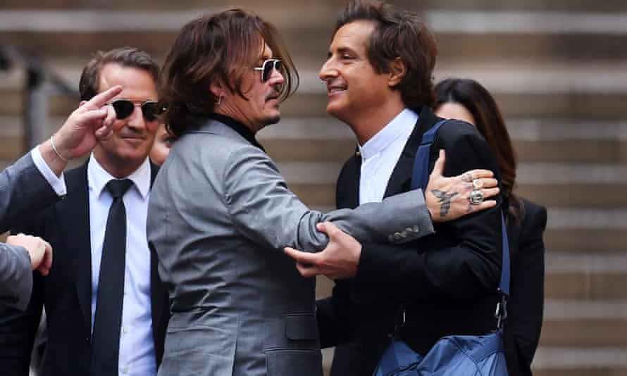 Johnny Depp hugs Sherborne outside the Royal Courts of Justice in 2020.