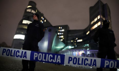 Police stand outside the Polish public television TVP building.