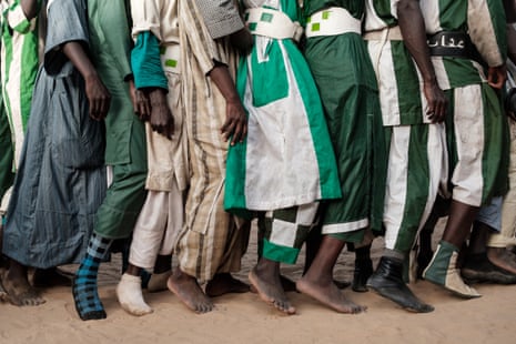 Followers of the Muslim sect Baye Fall march in a line