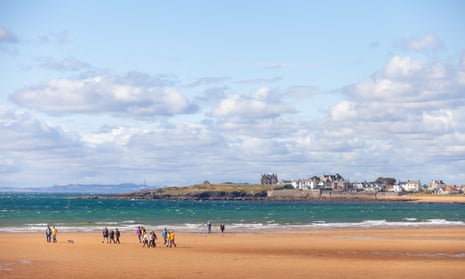 A large group of walkers on the beach at Elie.