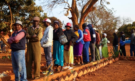People wait to cast their vote during the Zimbabwe general elections in Kwekwe, outside Harare, on Wednesday.