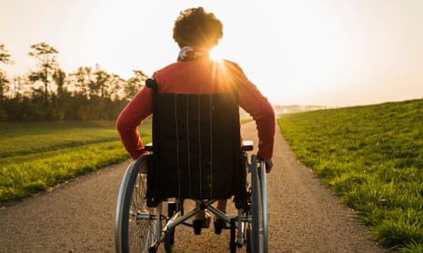 A woman in a wheelchair in a park