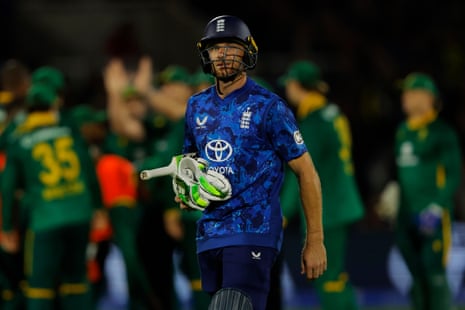 England's Jos Buttler walks off the pitch after he is bowled out by South Africa's Lungi Ngidi.