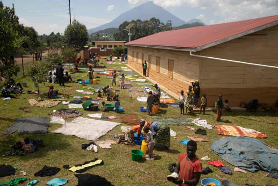 DRC refugees spread out their belongings at the Nyakabande center in Uganda.
