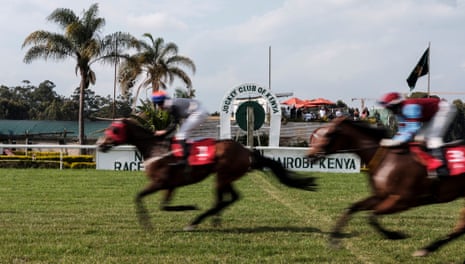 Riders cross the finish line on their horses.