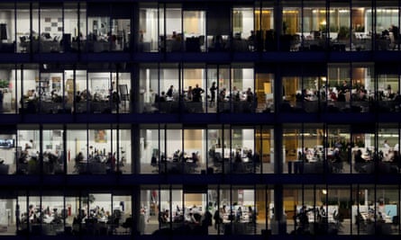 Office building with workers at night.