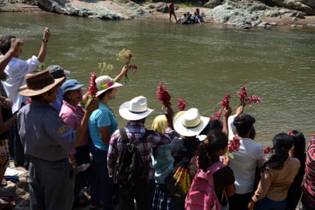 People honuor the late assassinated environmentalist Berta Cáceres with a religious ceremony on the Gualcarque River, Hondurans.