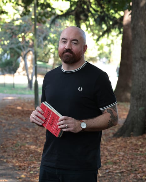 Man in a park holding a book
