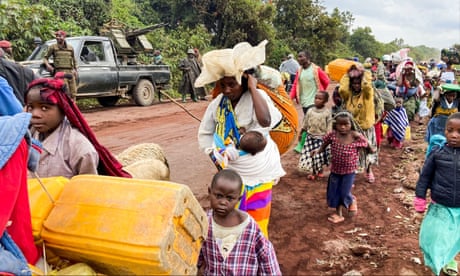 Congolese civilians carry their belongings as they flee near the Congolese border with Rwanda after fightings broke out in Kibumba, outside Goma in the North Kivu province of the Democratic Republic of Congo May 24, 2022. REUTERS/Djaffar Sabiti