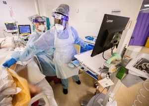 Seyi Adeleye cares for a patient on the Covid ward.