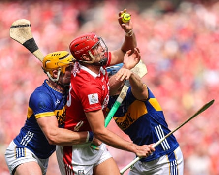 Cork’s Brian Hayes (centre) is tackled by Ronan Maher and Willie Connors of Tipperary, 20 July 2025.