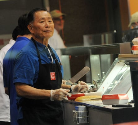 George Takei preparing food in an industrial kitchen in Celebrity Apprentice