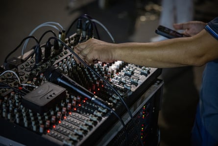 A DJ’s hands working a mixing desk
