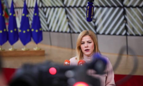 Evika Siliņa speaks into a microphone with European Union flags behind her to the left