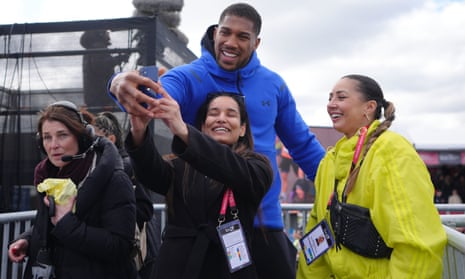 Anthony Joshua takes some selfies with fans before the race