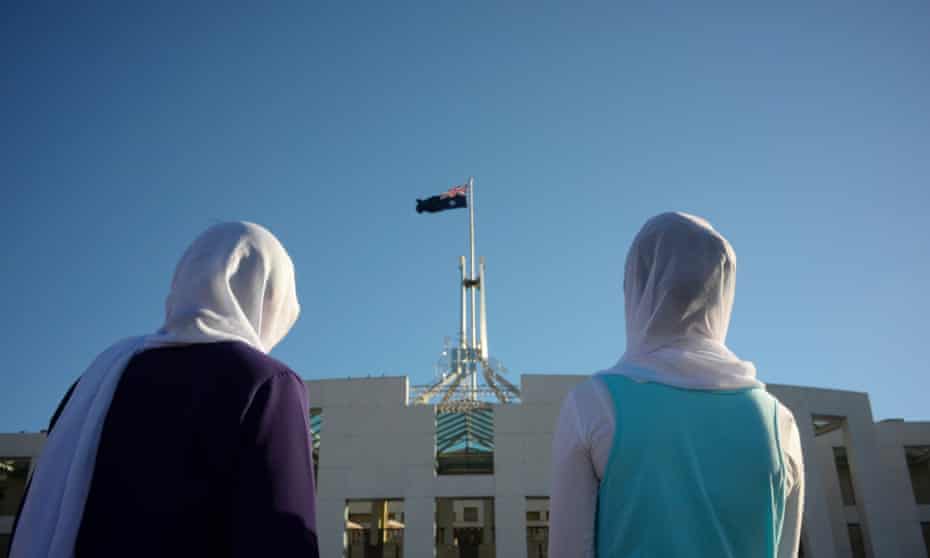 Visitors of Afghan nationality wearing hijabs are seen outside Parliament House in Canberra, 2 October 2014.