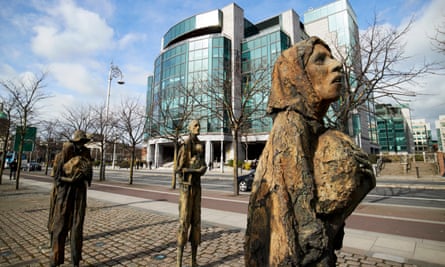 sculptures of woman and modern building in background