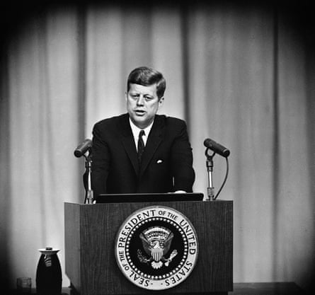a man speaks from behind a lectern
