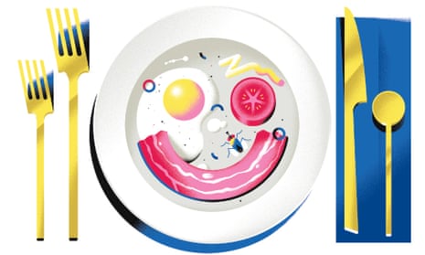 Plate with food in shape of a smiley face - fried egg and tomato as eyes and bacon as mouth - also has a spider on it