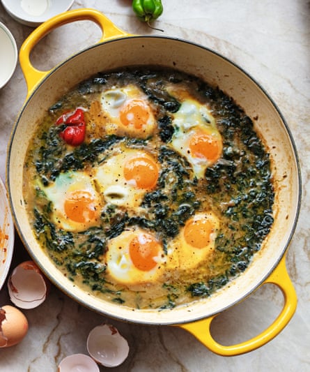 A yellow pan with spinach and eggs