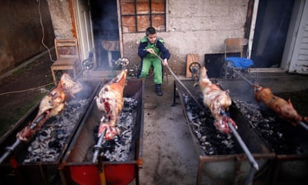 A Bosnian Serb boy roasting lamb and pig near Sarajevo.