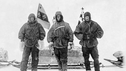 Black and white picture of Ernest Henry Shackleton, Capt Robert Falcon Scott and Dr Edward Adrian Wilson standing in front of a sled stacked with supplies