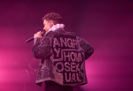 Alexander wearing a jacket with the slogan ‘Angry Homosexual’ on the back