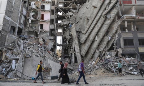 Palestinians walk through destruction in Gaza City on on 24 November.