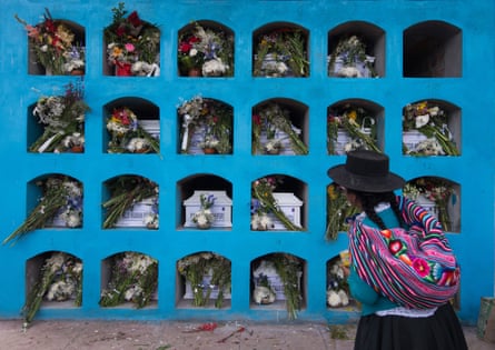 Residents of a village participate in the funeral of 23 of their relatives after their remains were recovered from a mass grave and identified via DNA testing in Huanta municipality, Ayacucho region, Peru.